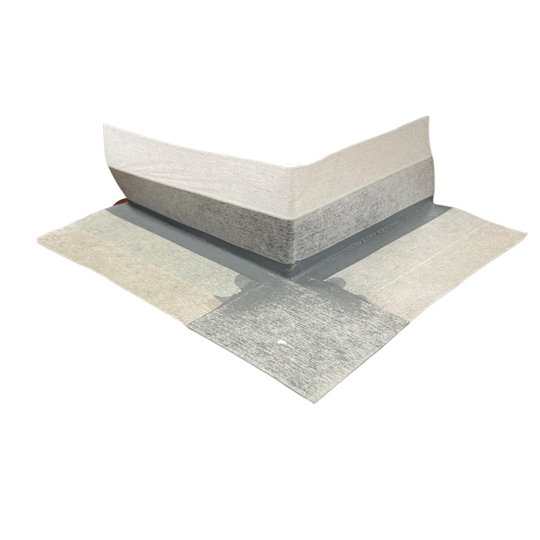Preformed external waterproofing corner with a flexible rubber centre and non-woven fleece backing, designed to reinforce external wall and floor corners, hobs, curbs, and movement joints in waterproofing membrane systems.