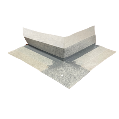 Preformed external waterproofing corner with a flexible rubber centre and non-woven fleece backing, designed to reinforce external wall and floor corners, hobs, curbs, and movement joints in waterproofing membrane systems.